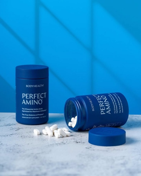 A clean, high-contrast product-centric image featuring two supplement bottles against a vibrant blue studio background.